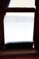 An old wooden window of an abandoned house close up