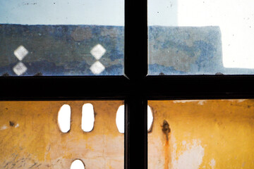 An old wooden window of an abandoned house close up