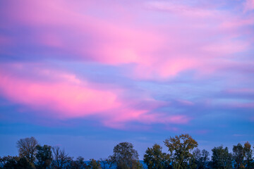 blue sky with purple magenta clouds at sunset