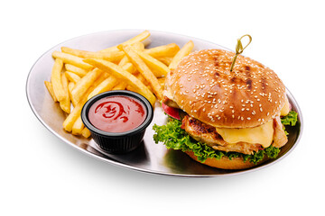 Delicious burger served with crispy fries and dipping sauce on a plate