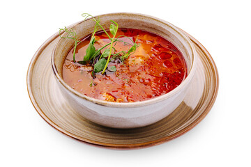 Delicious bowl of spicy tomato soup garnished with herbs and spices