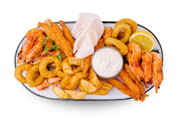 Seafood platter with fried shrimp, fish, onion rings, and sauce