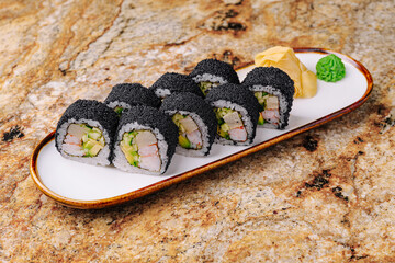 Enjoying delicious sushi rolls with fresh ingredients on a stylish plate