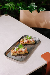 Delicious open-faced sandwiches served on a tray in a cozy cafe setting
