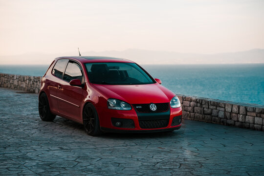 Red Volkswagen Golf GTI small car, German automobile