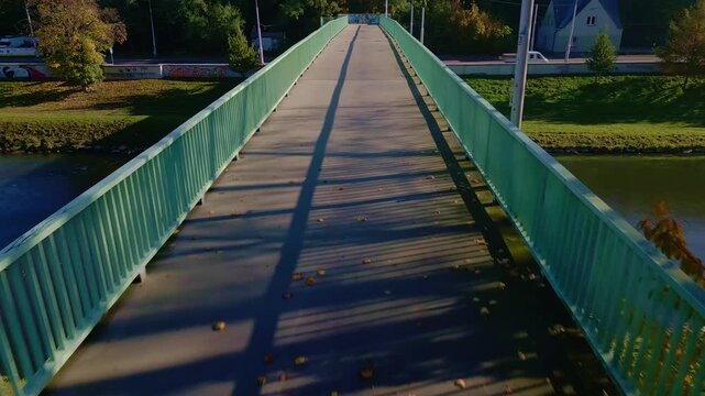 Drone Low reverse over footbridge reveals parallel linear perspective