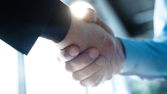 Partnership, teamwork and shaking hands for agreement, consulting or introduction in meeting
