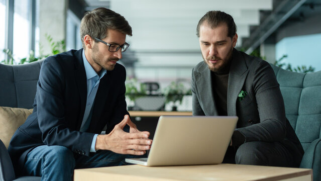 Businessmen discussing deal, sharing startup ideas, business partners negotiations or job interview in modern office
