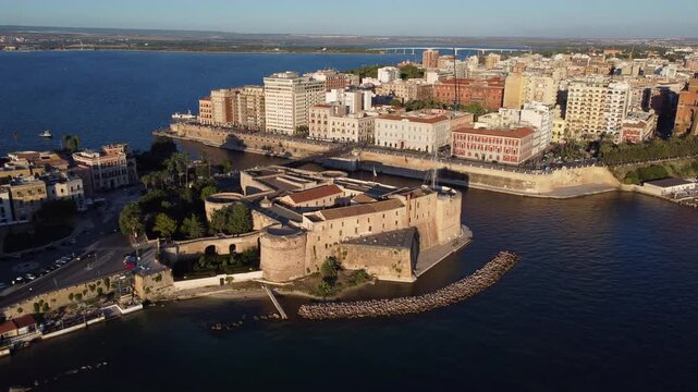 Aerial flying backwards from Castello Aragonese in Taranto, Italy