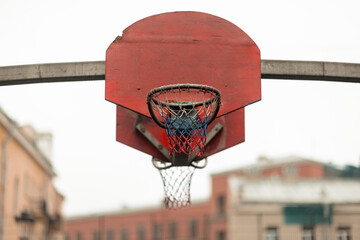 Action basketball hoop on an outdoor court in an urban environment