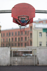 Action basketball hoop on an outdoor court in an urban environment