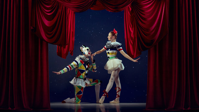 Life as performance. Mime kneeling before ballerina under red curtain. Concept of admiration, contrast, emotion, humor used for storytelling, and social media content.