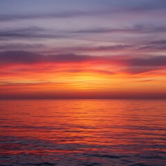 Fototapeta premium A magnificent sunrise paints the tranquil ocean surface with vibrant hues of gold, red, and soft lavender light, creating a peaceful, reflective seascape ,seascape ,marine ,pink