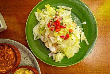 Carnitas tacos mixed with all parts of the pork, served with tomatillo and lime sauce