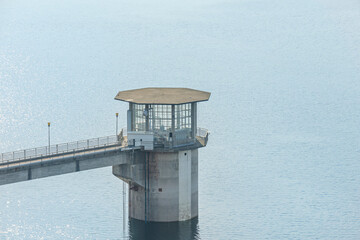 Stormy sunset where sunbeams create dramatic effects on the reservoir, illuminating specific areas...