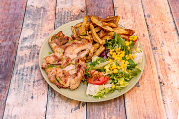 A wonderful dish of Brito chicken with homemade potatoes and mixed salad