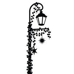 Ornate black street lamp with hanging stars and vine accents