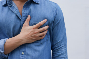 close up man feeling suffering and using hand for touching on chest for checking about his heart attack symptom or respiratory on white background for health lifestyle concept