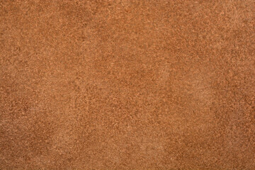 A horizontal full-frame macro shot captures the uniform, fuzzy, nappy texture of a plain brown...