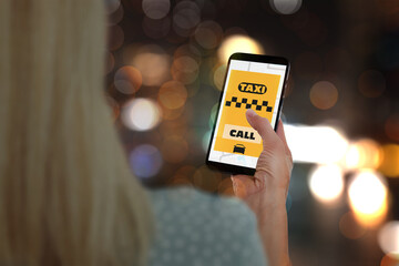 Woman using app on mobile phone to call taxi on city street, closeup © New Africa