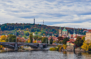 Obraz premium Prague Cityscape Autumn Panorama Vltava River Historic Bridges Church Architecture Fall Foliage Czech Republic European Travel Destination. Ultra HD