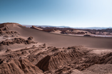 Golden desert sands with rugged ridges in Chile&rsquo;s Valle de la Luna