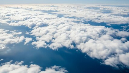 Aerial view of fluffy clouds over a dark blue sea or ocean surface - Powered by Adobe