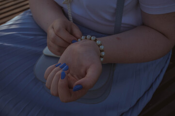 Close-Up of a Girl with Chubby Hands Admiring a Bracelet in Casual Style