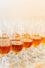 Glasses of Sparkling White Wine or Champagne on Table – Elegant Beverage Setup for Celebration, Wedding Reception or Event Catering with Golden Light Reflection