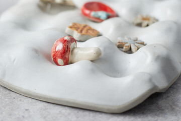 ceramic tray for jewelry on gray background.