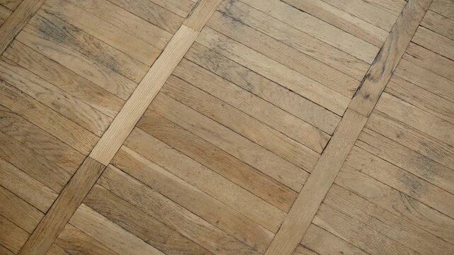 Aged oak wood floor pattern with chevron design and straight inlay strip texture