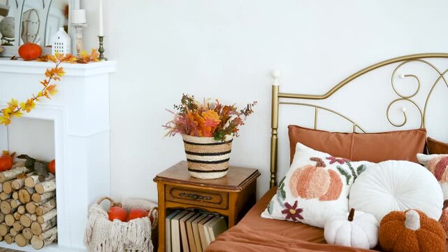 Cozy bedroom with autumn decor pumpkins and fall foliage on mantelpiece