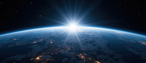 Breathtaking view of Earth from space, showcasing curvature of planet and sun rising above horizon, illuminating clouds and land below