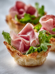 food photography, one mini phyllo quiche with lot of fresh turkey ham slices on a white background, 