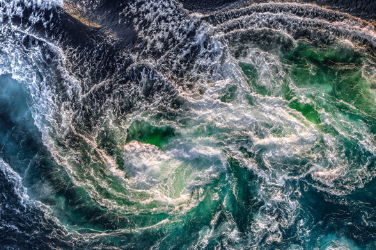 Blue waves of water of the river and the sea meet each other during high tide and low tide.