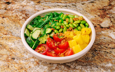 Fresh vegetable bowl with vibrant greens and fruits for healthy eating
