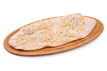 Freshly baked flatbread topped with sesame seeds on a wooden platter