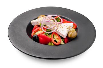 Fresh salad with feta cheese, olives, and colorful vegetables in a black bowl