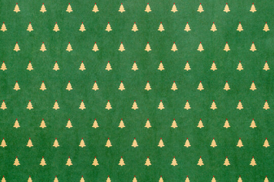 Green Christmas background with snowflakes and christmas trees,seamless pattern of christmas trees and snowflakes on green background,Christmas wrapping paper, Xmas pattern with ornaments.