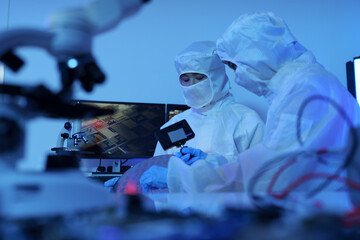 Technician working on analyzing semiconductor or microchip boards, electronics industry, electronic engineer, computer technology, CPU maintenance, hardware, motherboard component upgrades.