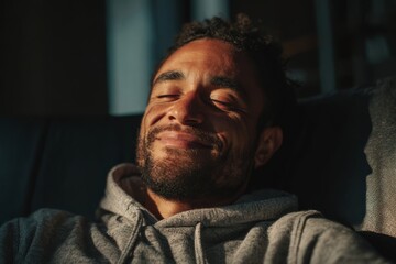 Man leaning back in chair with gentle smile, expressing contentment and balance.