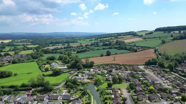 Tiverton, Devon, England: DRONE VIEWS: The Grand Western Canal winds through a suburb: it is a popular tourist attraction. Tiverton is the commercial and administrative centre for mid-Devon (Clip 1).