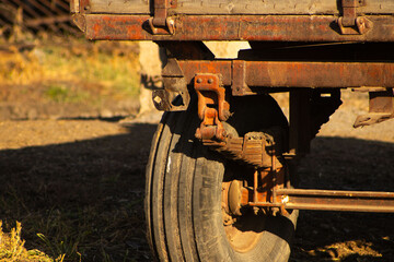 Close-up of Rusted Metal Chassis and Leaf Spring Suspension on an Old Farm Trailer