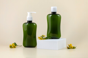 green containers for skin care products and yellow flower petals on a pale yellow background