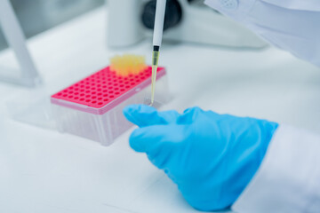 Laboratory technician conducting a pipetting procedure with samples in a research setting