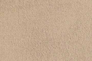 Fototapeta premium Close-up texture of natural beige sandy beach surface
