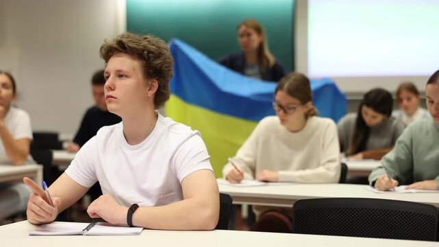 Teacher with the flag of Ukraine tells the history of the emergence of the state. High quality 4k footage