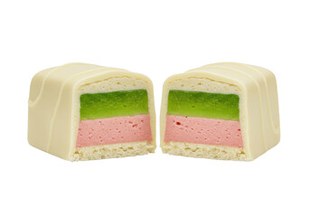 Isolated confection cross sections display green jelly and pink cream under a white chocolate