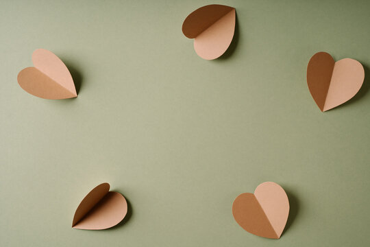 Paper Hearts on Green Background
