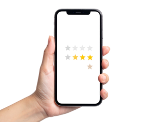 Hand holds a smartphone displaying a rating with three yellow stars on a white screen against a black background